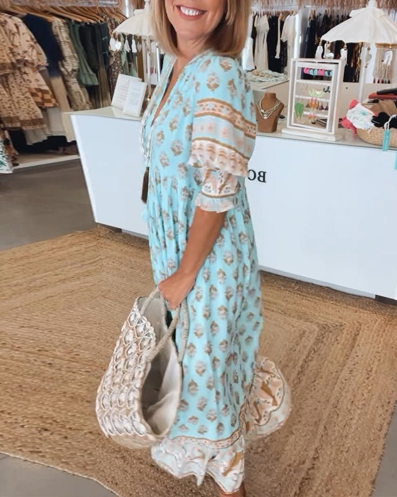 Side view of light blue floral maxi dress showing tiered skirt and lace trim