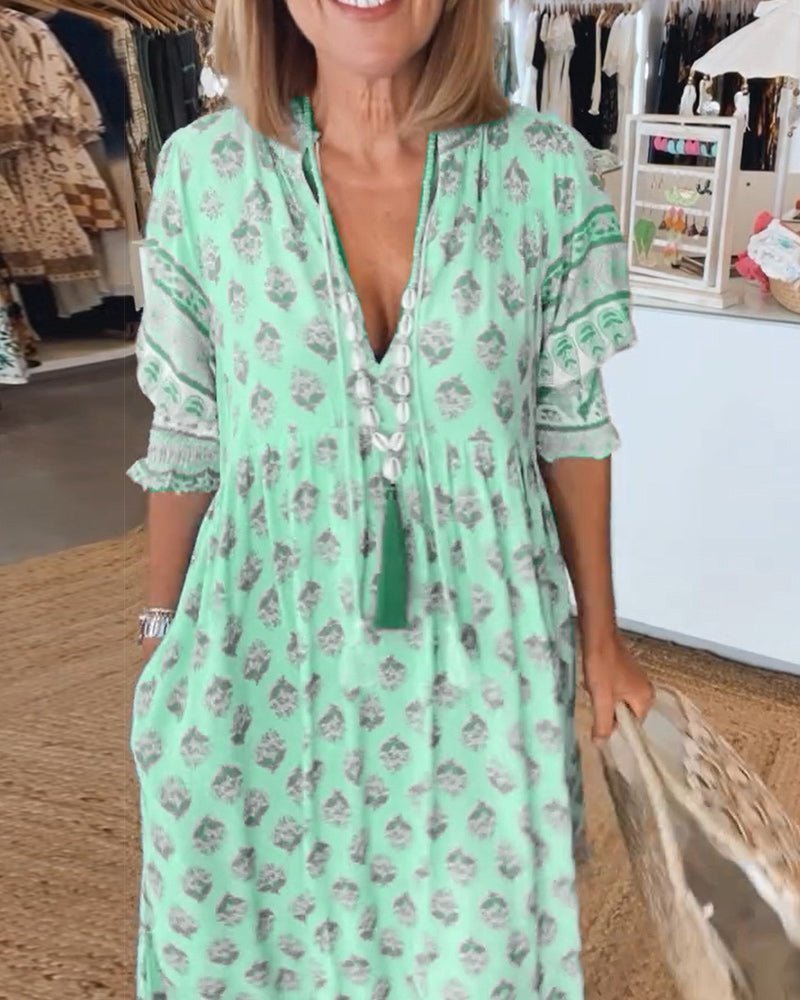 Back view of mint green floral tiered maxi dress with ornate lace panels