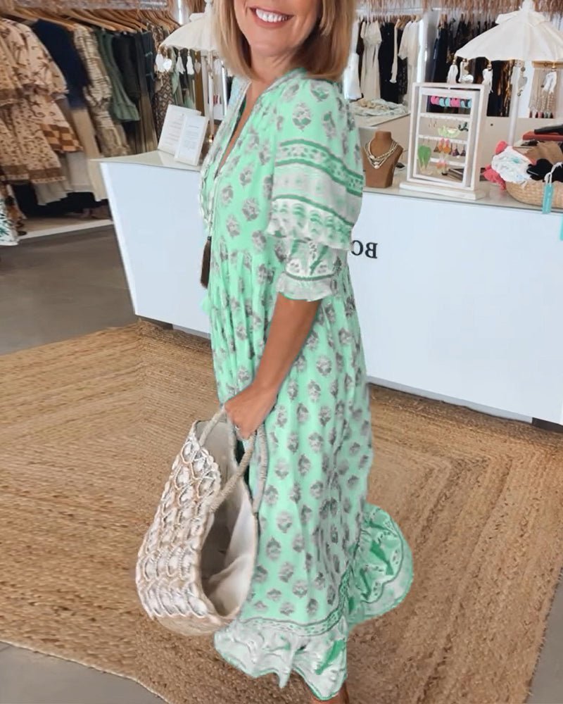 Side view of mint green floral maxi dress showing tiered layers and lace hem