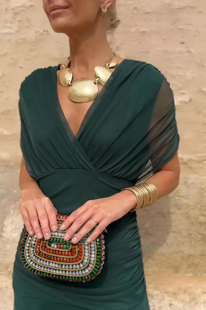 Forest green draped maxi dress close-up showing wrapped bodice and V-neckline