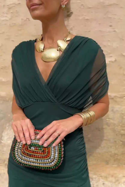 Forest green draped maxi dress close-up showing wrapped bodice and V-neckline