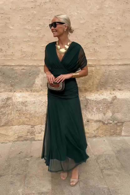 Forest green draped maxi dress with short sleeves and flowing skirt