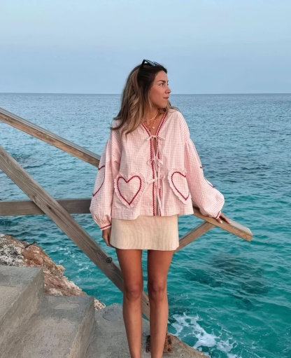 Pink and white checkered ruffle top with heart pockets worn with cream skirt