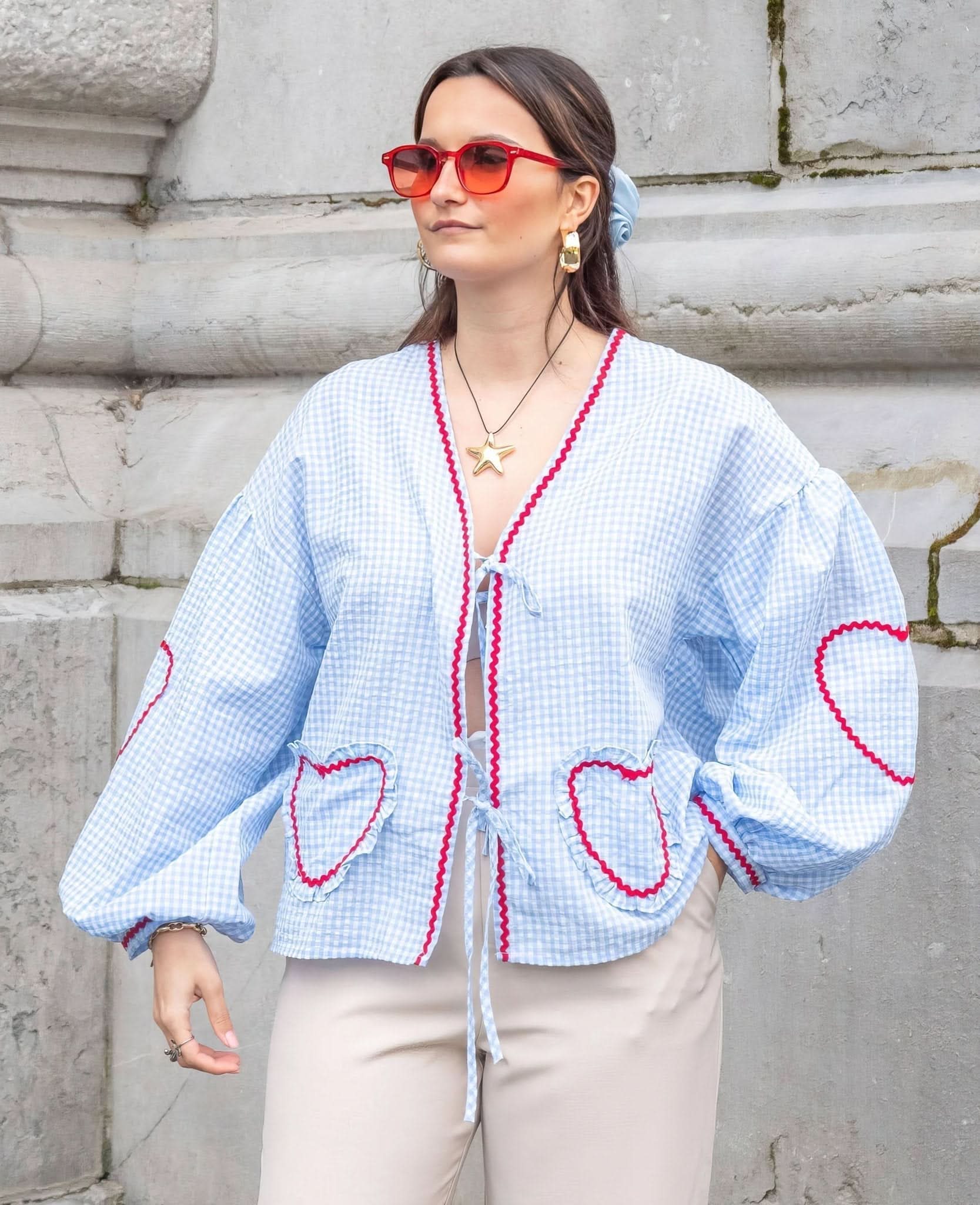 Light blue gingham ruffle top with red heart pockets and front tie