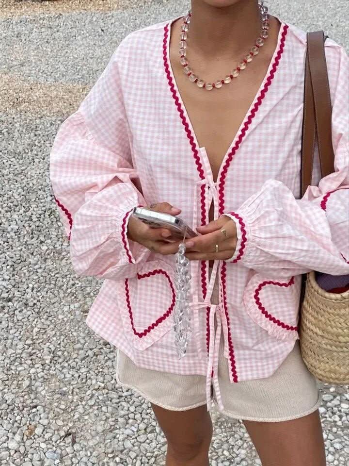 Pink gingham ruffle top with heart-shaped pockets and tie-front closure