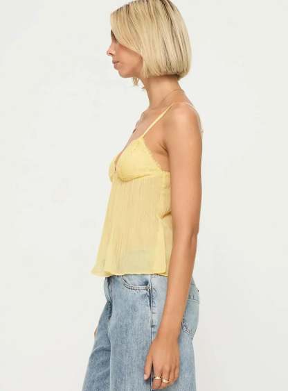Side profile of pale yellow pleated cami with lace bust