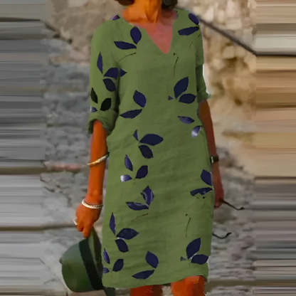 Green leaf print mini dress with relaxed shift fit and short sleeves