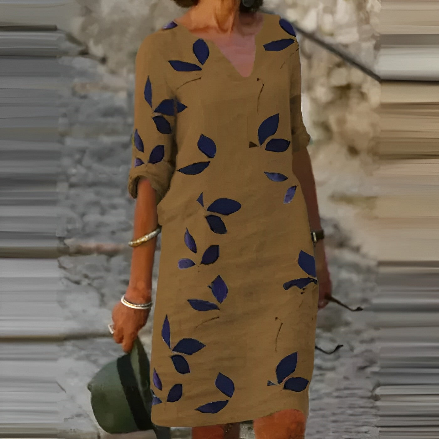 Mustard leaf print mini dress with navy leaf pattern and V-neck