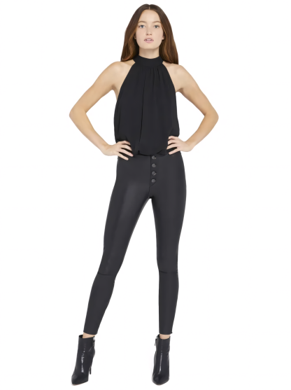Black halter mini dress with pleated bodice and high-waisted leather pants