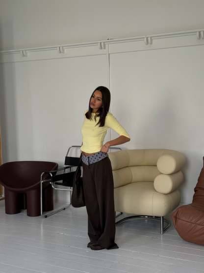 Black tailored pants with sage polka dot waistband, full-length side view