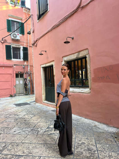 Black tailored pants with sage polka dot waistband, back view angle