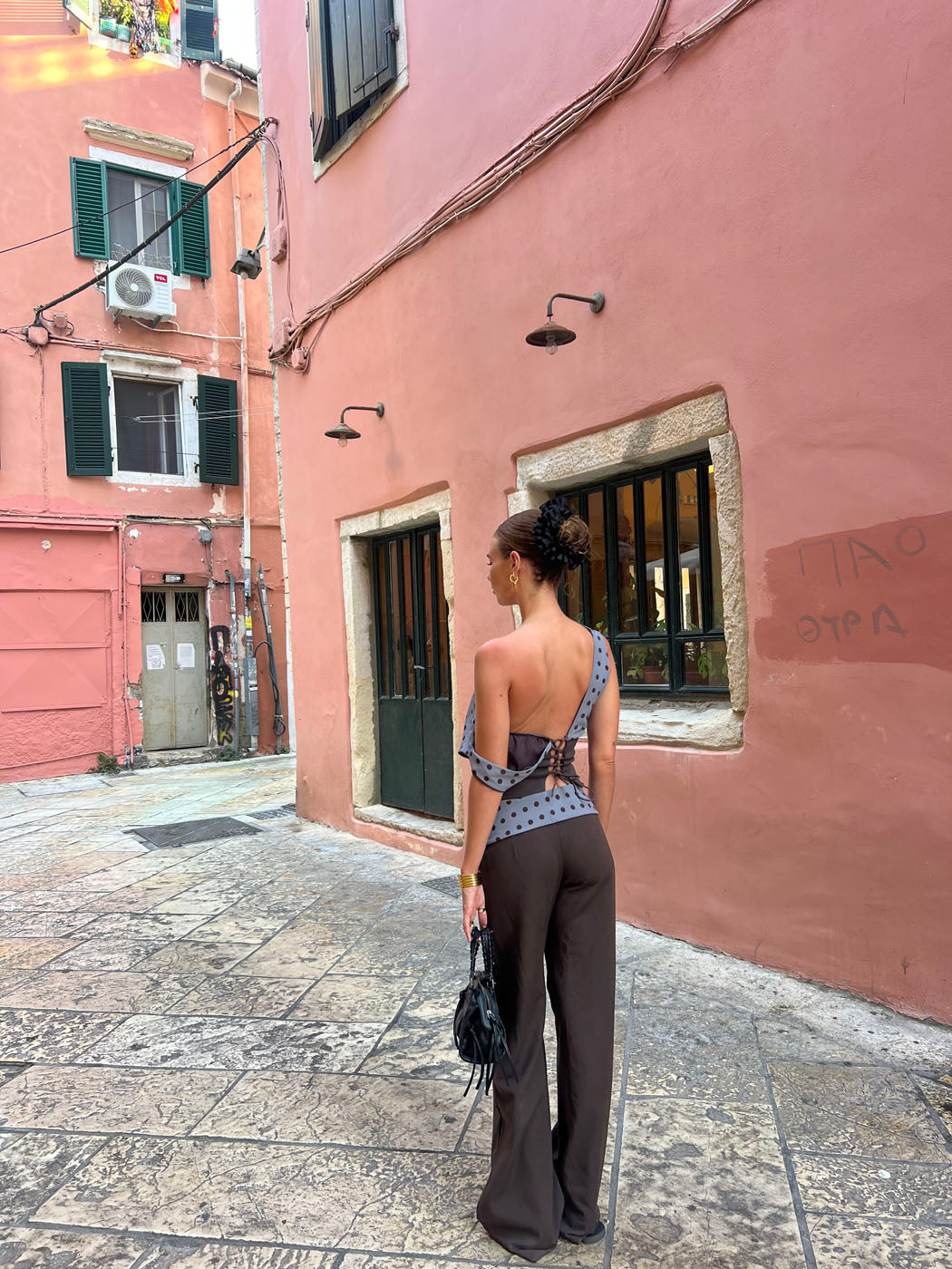Black tailored pants with sage polka dot waistband, straight-on front view