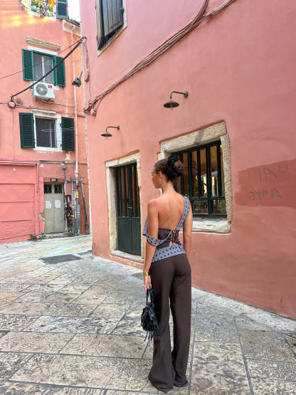 Black tailored pants with sage polka dot waistband, straight-on front view