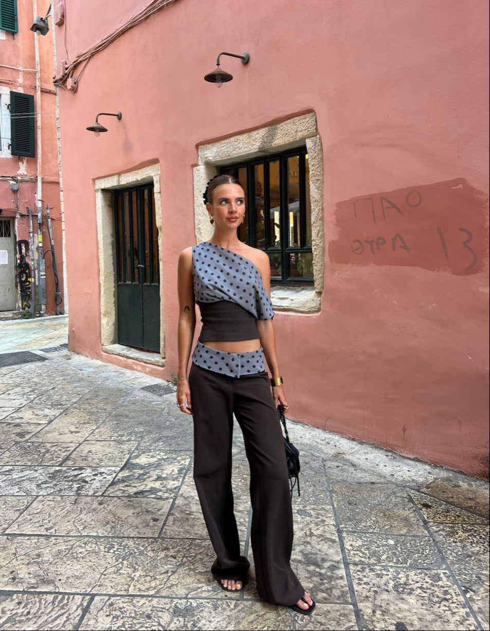 Black tailored pants with sage polka dot waistband, front view on model