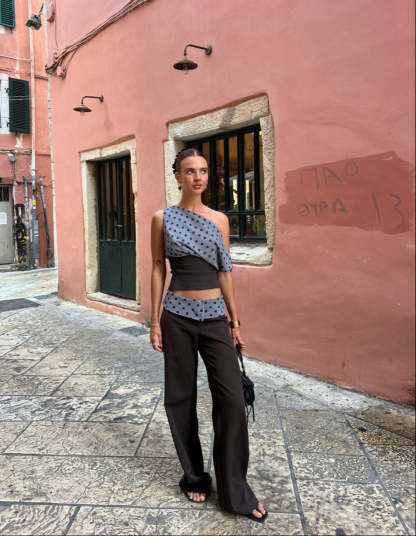 Black tailored pants with sage polka dot waistband, front view on model