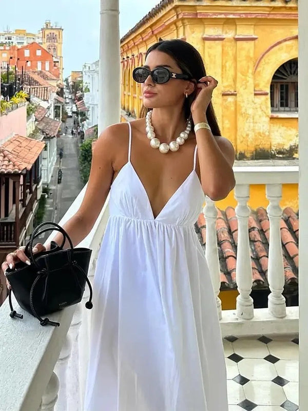 White spaghetti strap maxi dress with empire waist and flowing skirt, front view with V-neckline