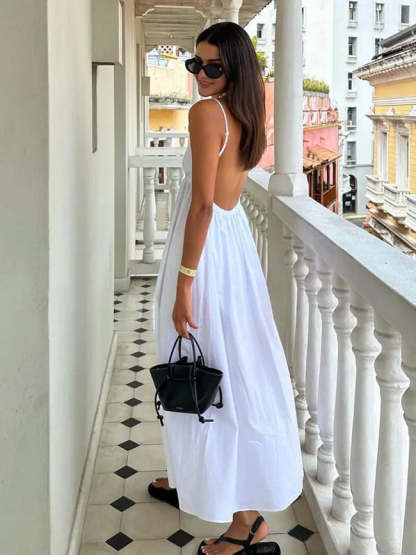 White backless maxi dress with deep V-neckline and open low back, shown from rear angle