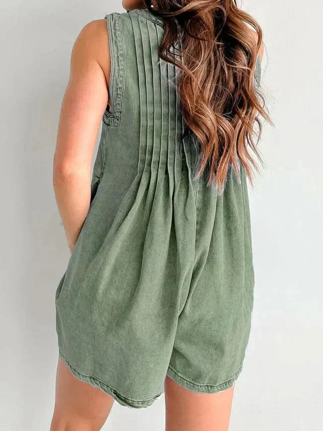 Sage green romper back view displaying pleated bodice and relaxed silhouette