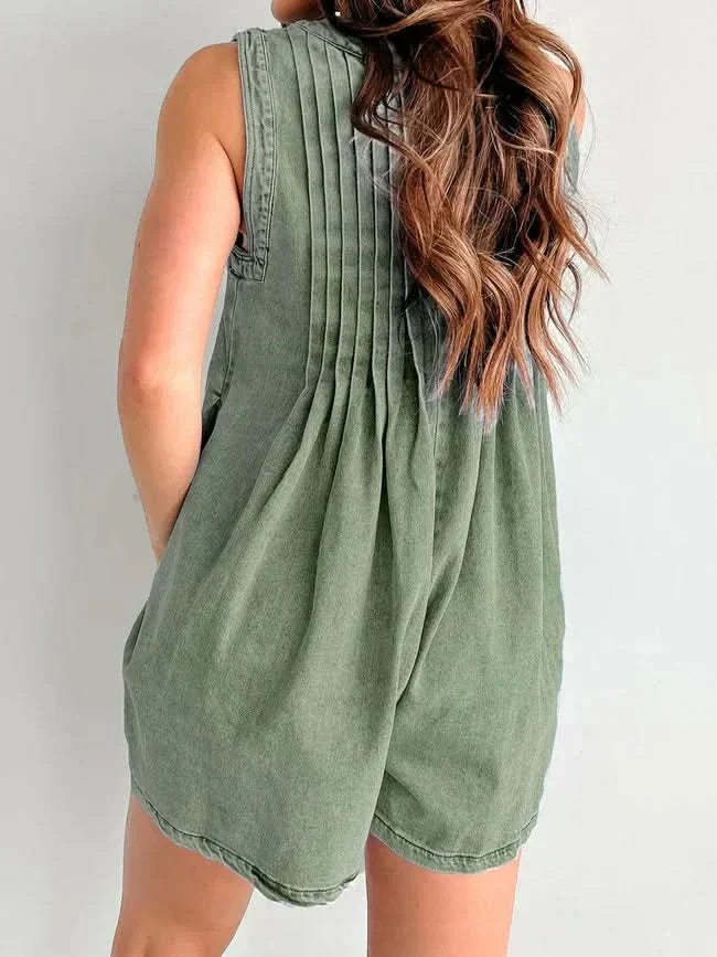 Sage green romper back view displaying pleated bodice and relaxed silhouette