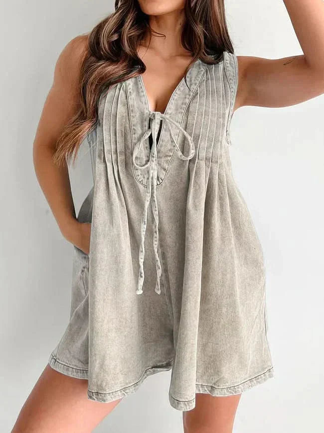 Cream lace-up mini romper with vertical pleats and tie front closure