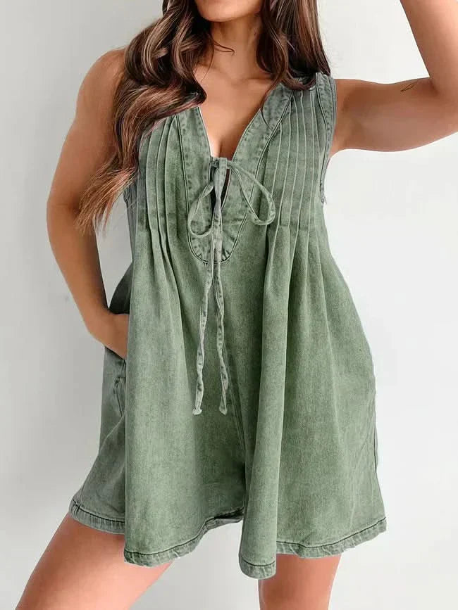 Sage green lace-up mini romper with pleated front and V-neckline