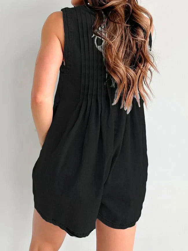 Black lace-up romper back view showing pleated design and side pocket