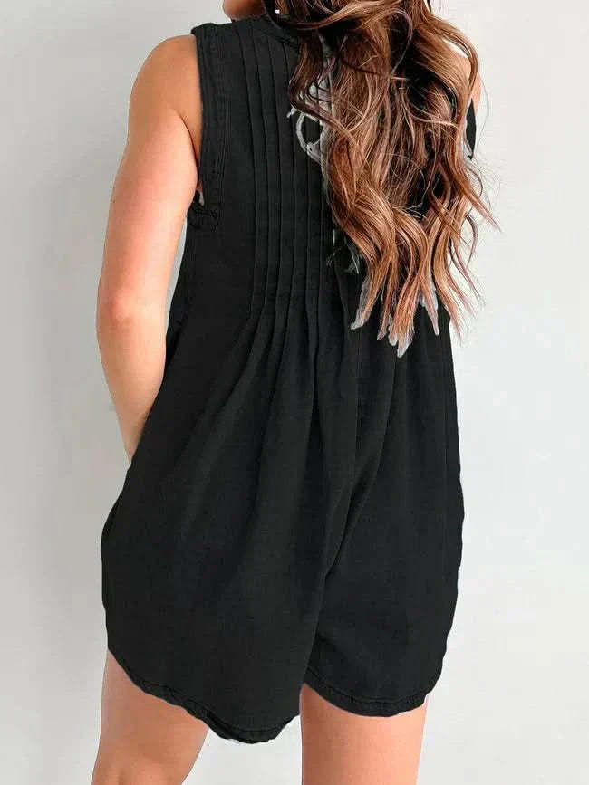 Black lace-up romper back view showing pleated design and side pocket