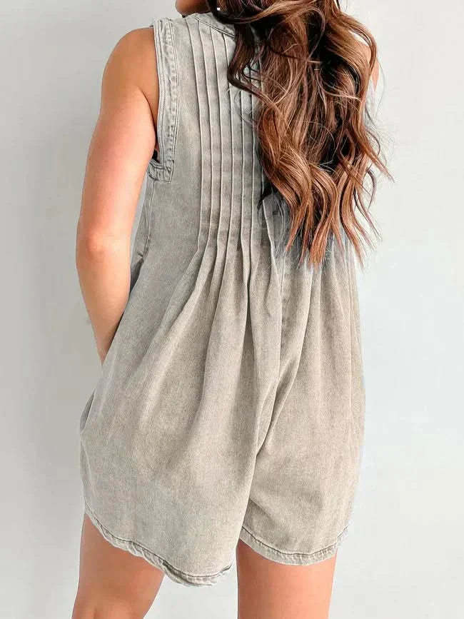 Cream denim romper back view with vertical pleats and curved hem