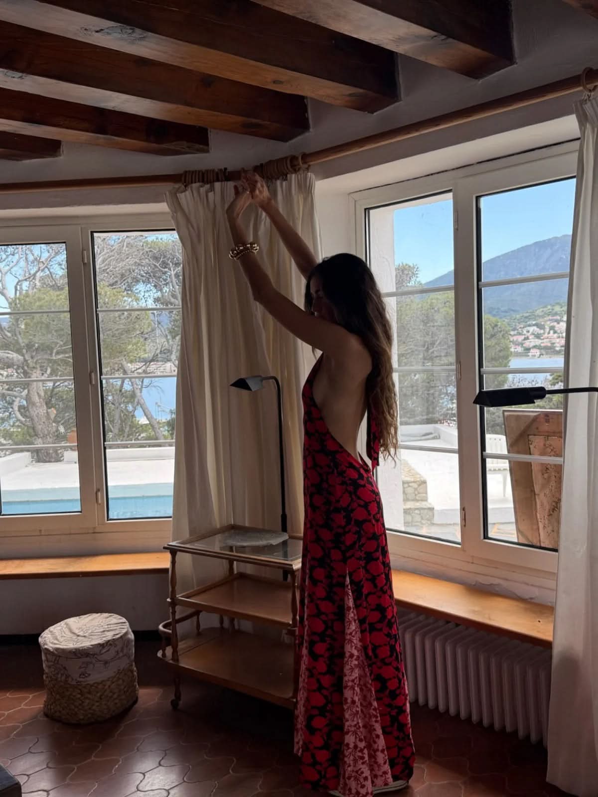 Back view of red floral maxi dress with open back and flowing train