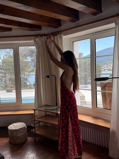 Back view of red floral maxi dress with open back and flowing train