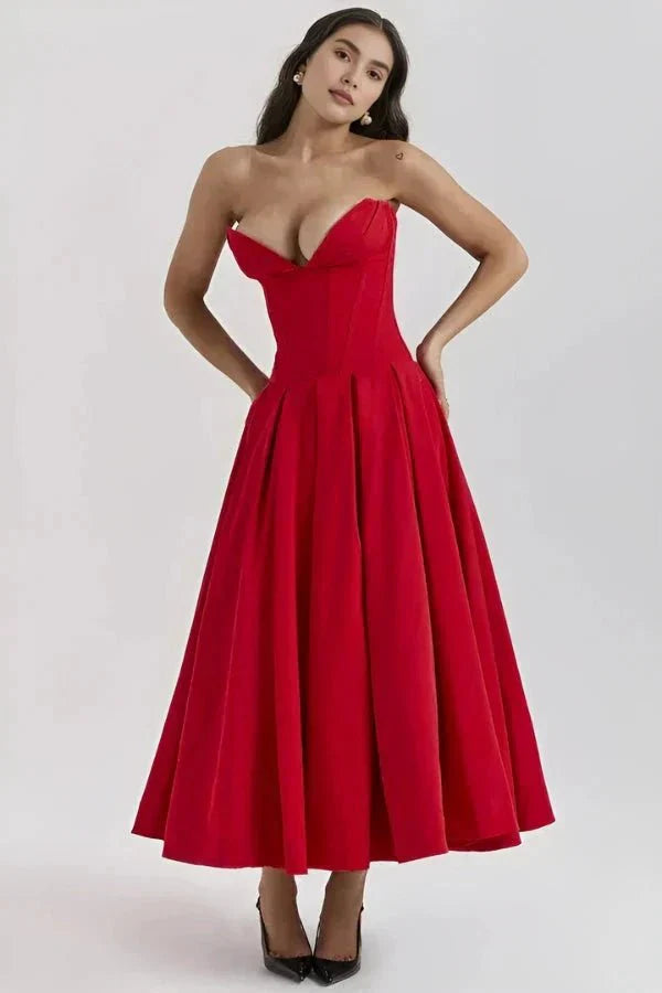 Red corset midi dress with structured sweetheart bodice and voluminous pleated skirt