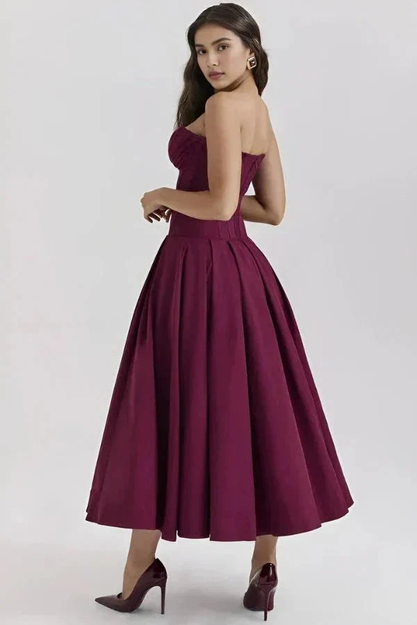 Burgundy corset midi dress back view showing open back and pleated skirt