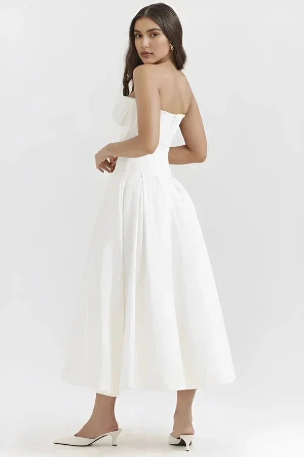 Back view of white strapless corset dress with structured bodice and flowing skirt