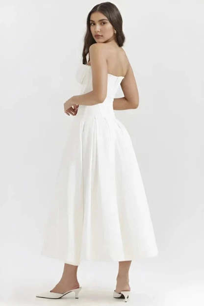Back view of white strapless corset dress with structured bodice and flowing skirt