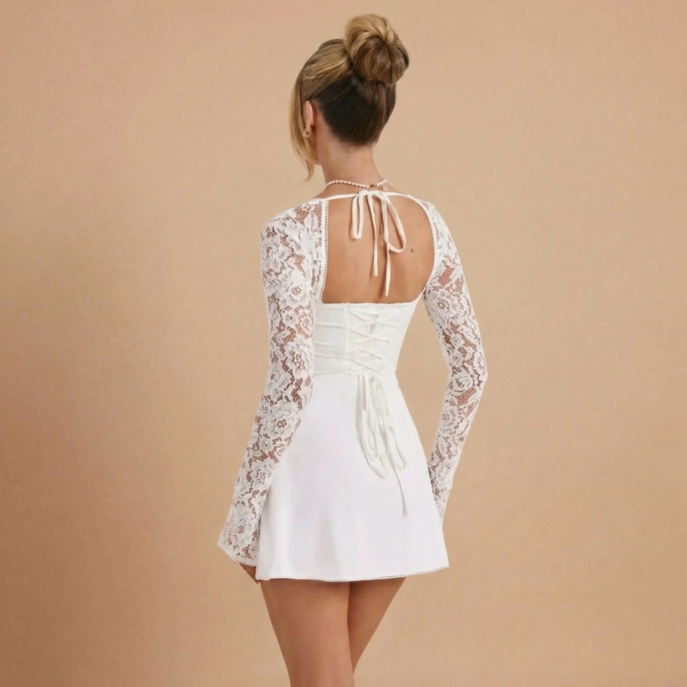 Back view of white lace mini dress showing open back with tie closure