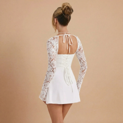 Back view of white lace mini dress showing open back with tie closure