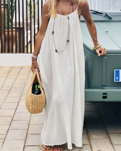 Cream sleeveless maxi dress with gathered bodice and flowing skirt