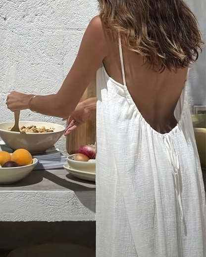 White backless maxi dress worn from behind showing deep V-back cutout