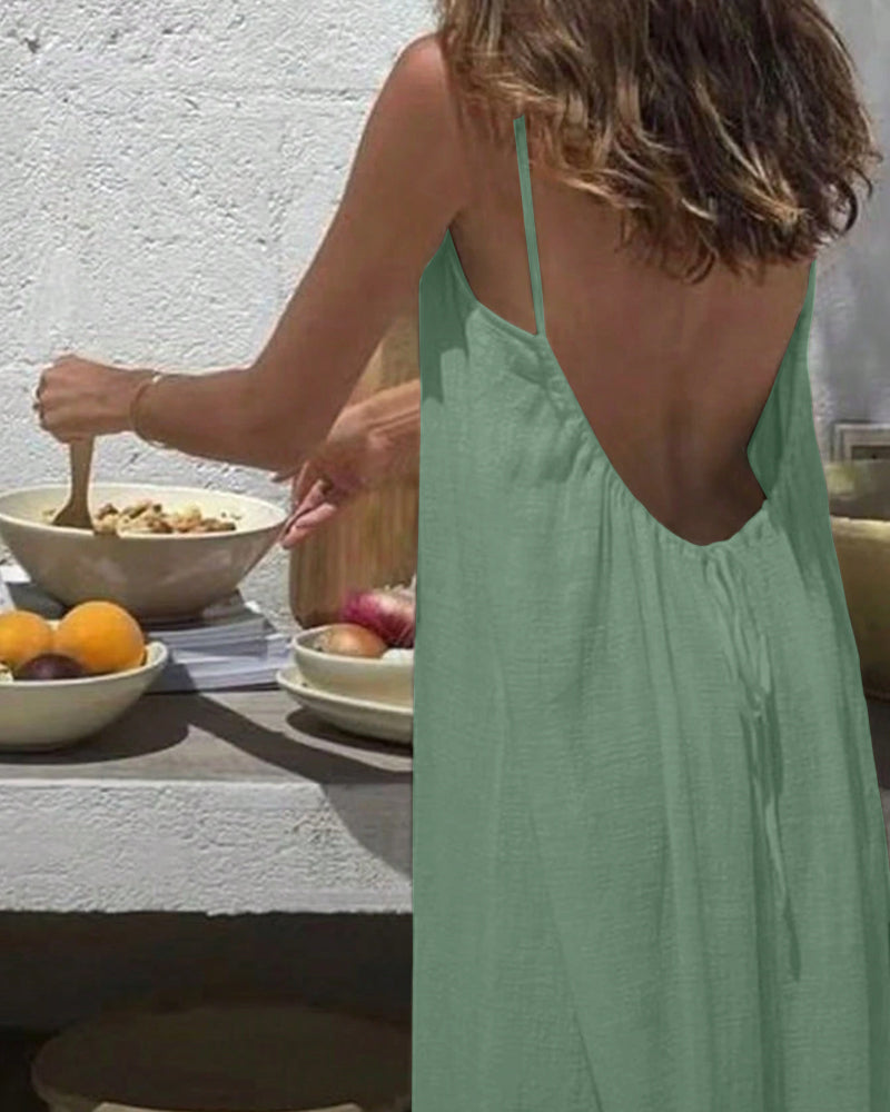 Sage green textured maxi dress worn from back showing open backless design
