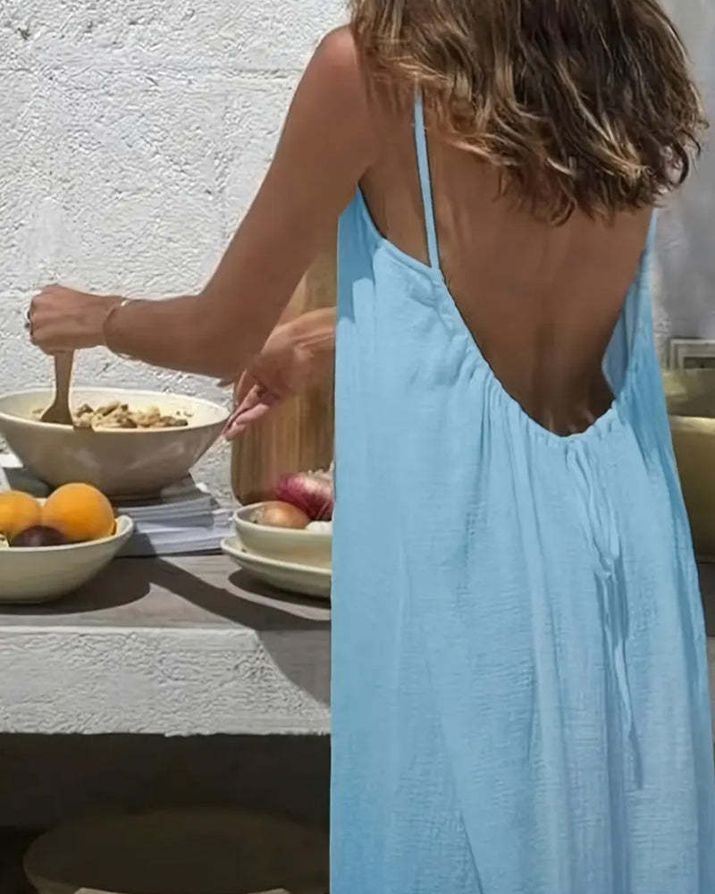 Back view of light blue backless maxi dress showing open back design and draped fabric