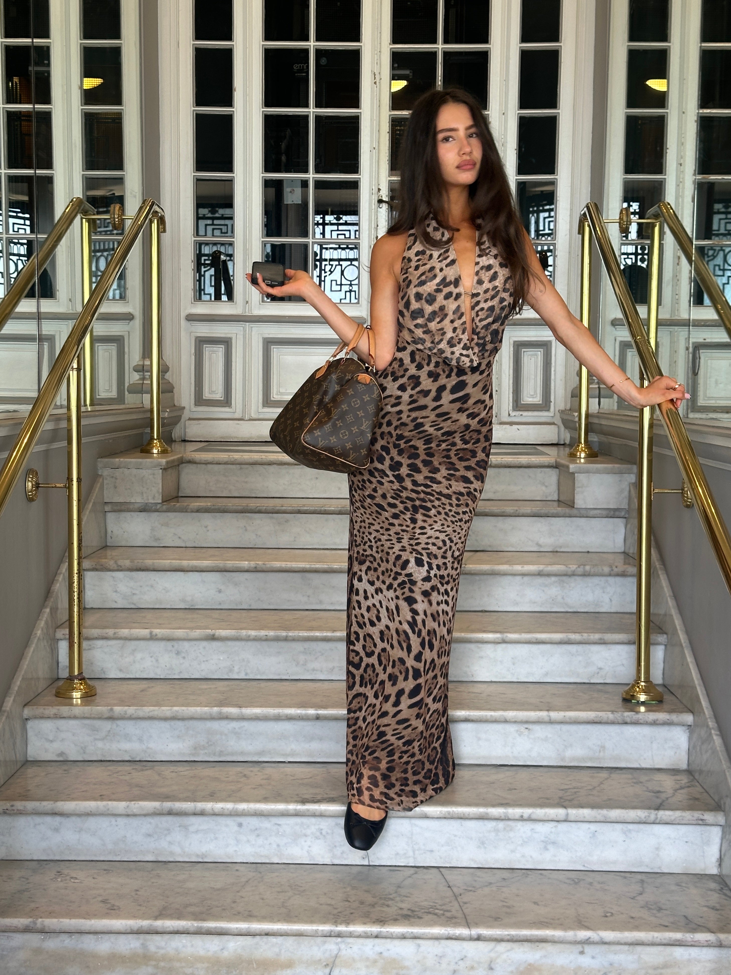 Leopard print maxi dress with plunging halter neckline and backless design