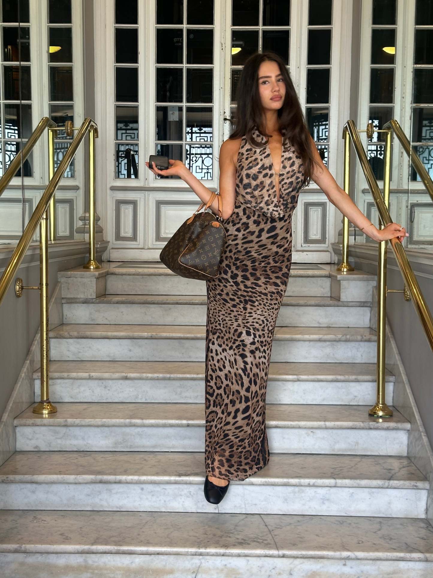 Leopard print maxi dress with plunging halter neckline and backless design