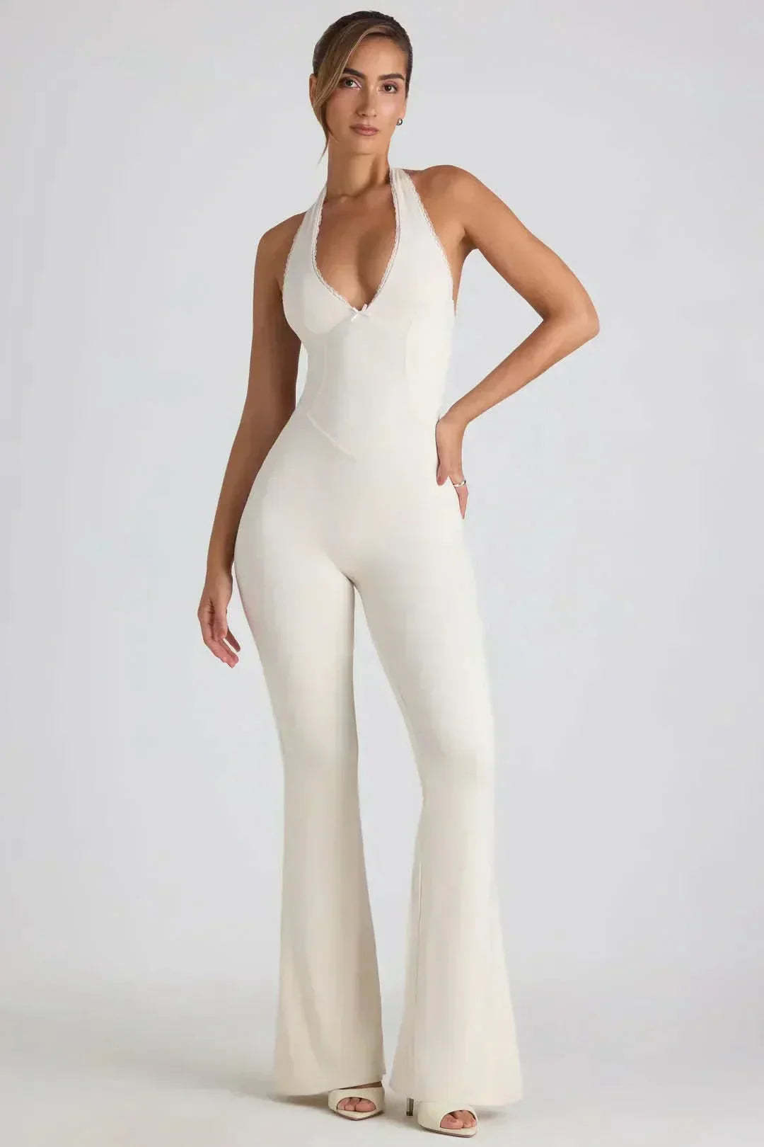 Cream halter backless jumpsuit with V-neck and wide-leg silhouette front view