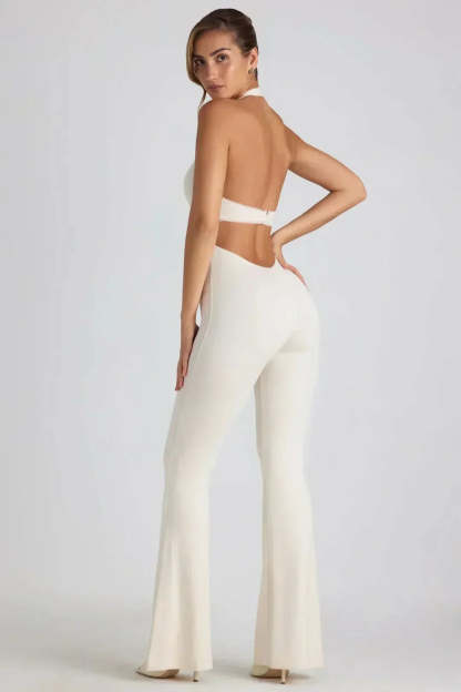 Back view of white backless maxi jumpsuit showing open back design