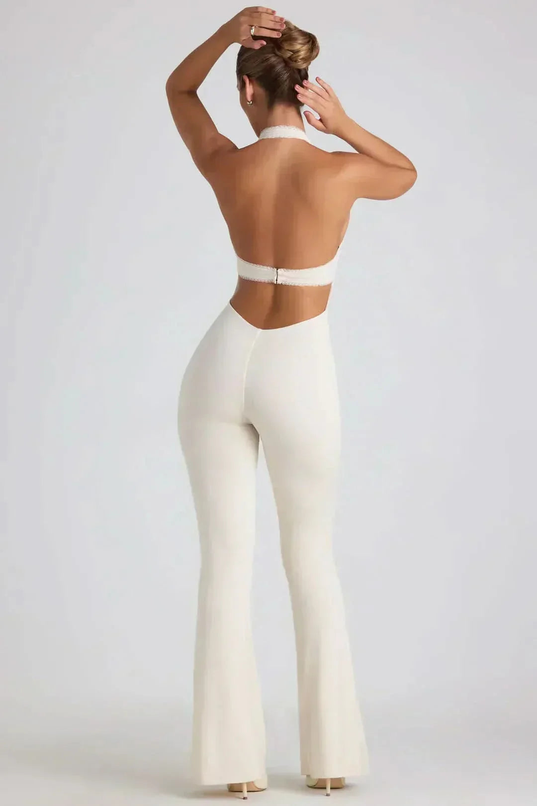Rear view of cream backless jumpsuit with low-cut back and flared pants