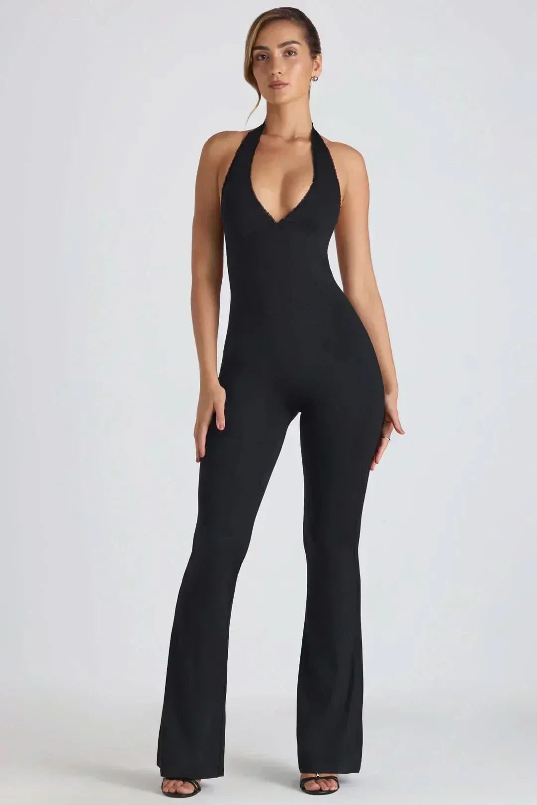 Black halter backless maxi jumpsuit with V-neckline and flared legs