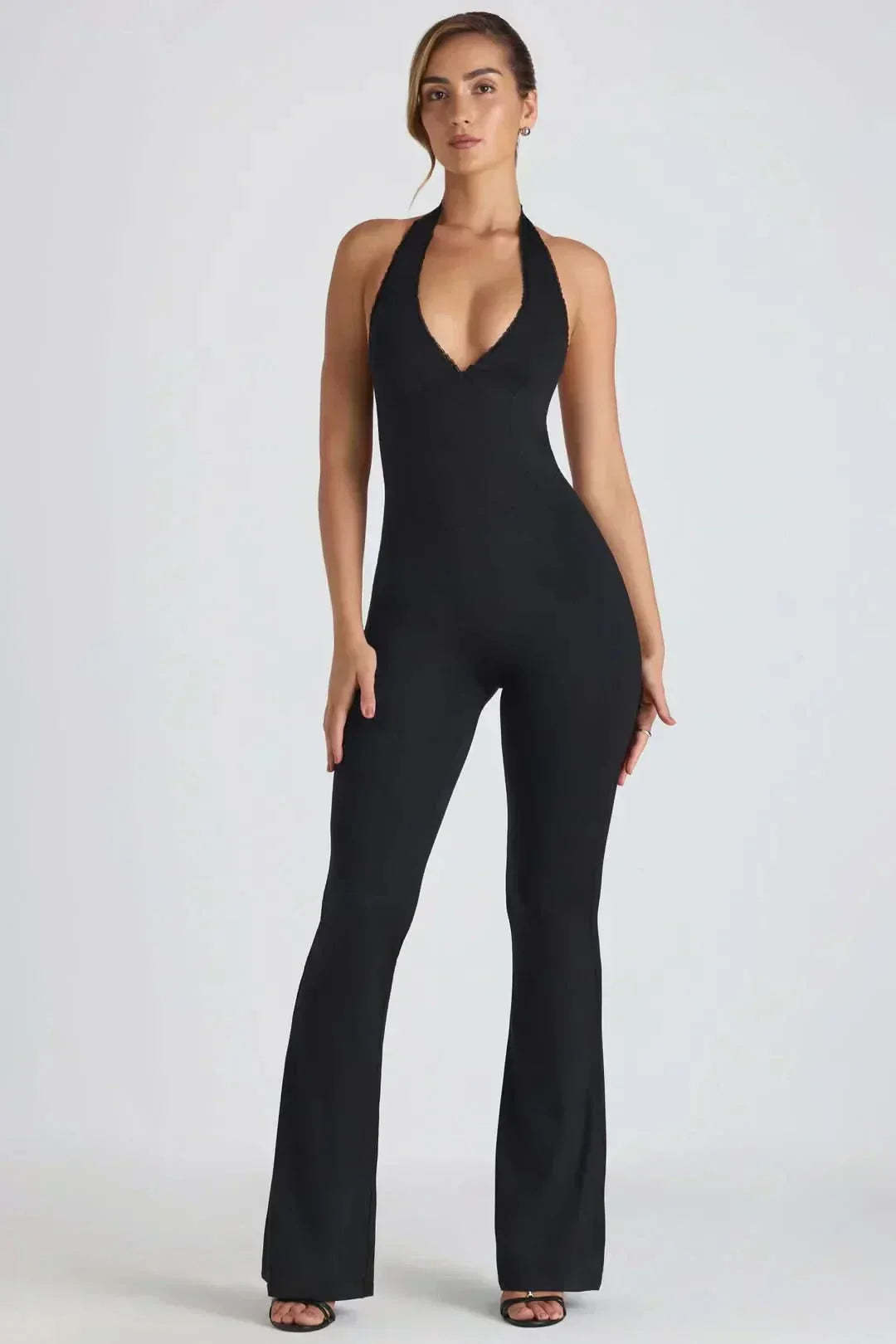 Black halter backless maxi jumpsuit with V-neckline and flared legs