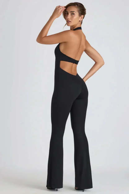 Back view of black backless jumpsuit showing open back and flared silhouette