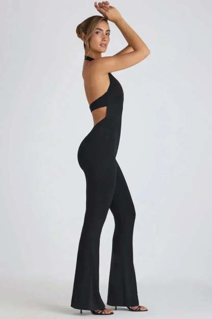 Side view of black backless maxi jumpsuit with cutout waist detail