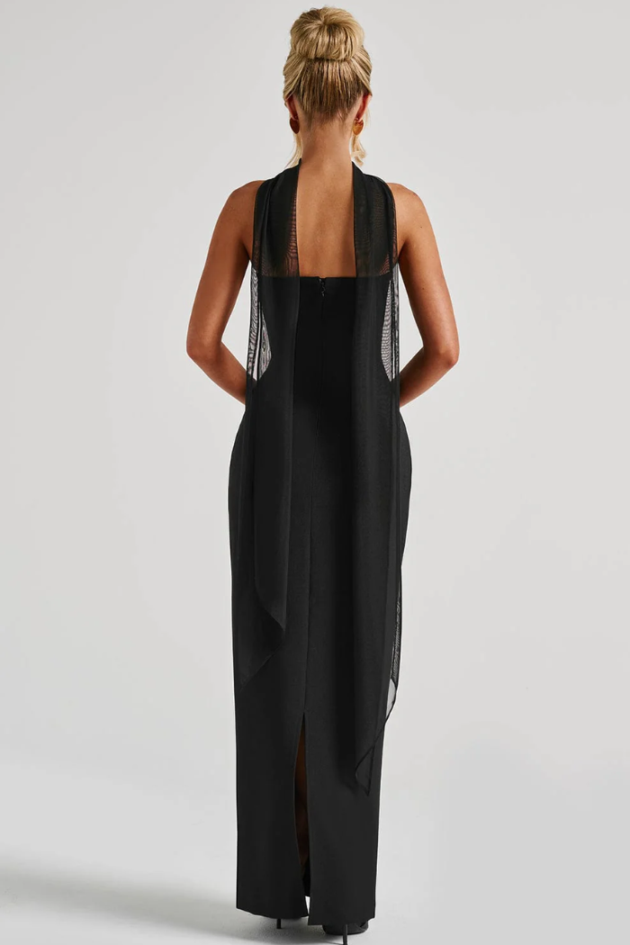 Back view of black bodycon maxi dress with sheer mesh overlay and open back